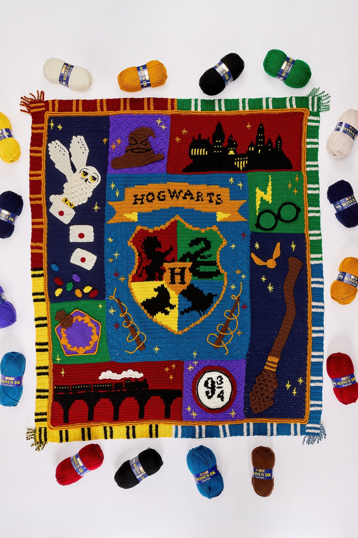 Harry Potter Journey to Hogwarts Crochet Along kit: the finished blanket from above, ringed by the 16 balls of Bonus DK