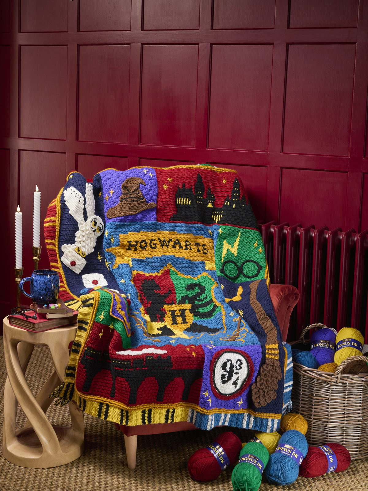 The Harry Potter Crochet Along blanket draped over an armchair with balls of Bonus DK
