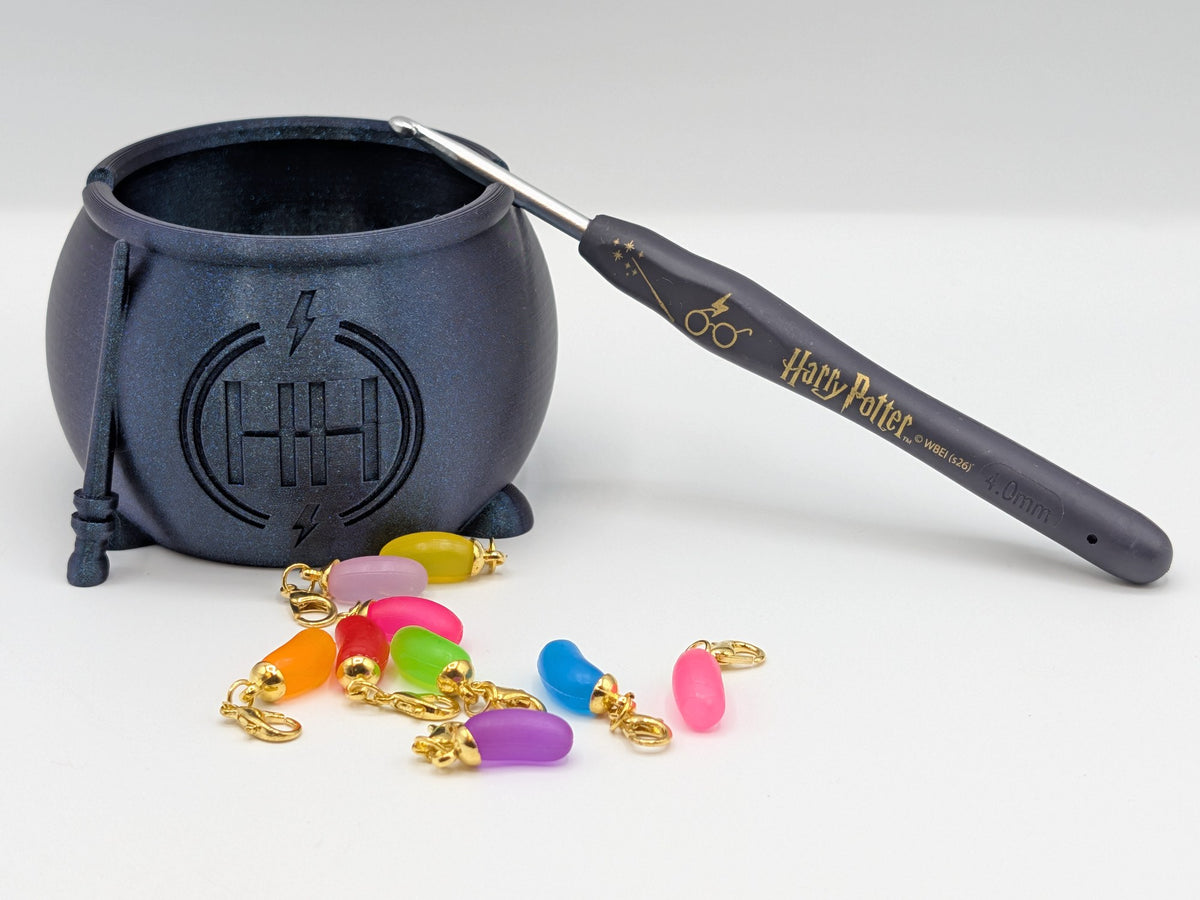 Free Homend cauldron hook holder with the hook leaning on it and stitch markers in front